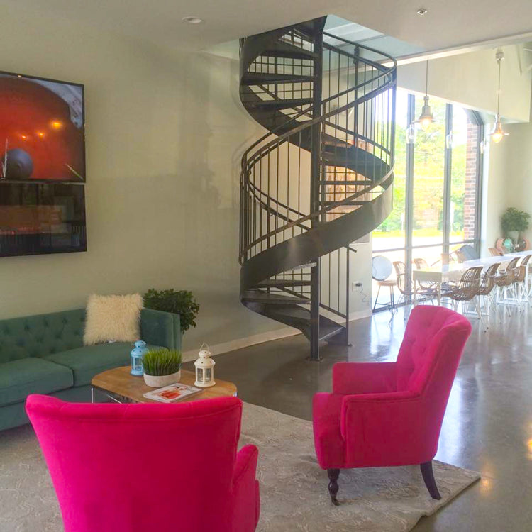 Custom fabricated metal staircase by BAMPRO — floating steel design with wood treads